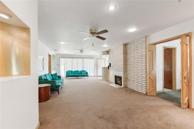 carpeted living room featuring ceiling fan and a fireplace