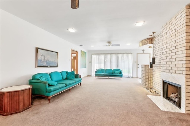 living room with ceiling fan, a fireplace, and light colored carpet