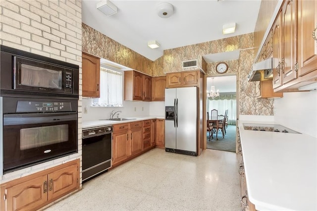 kitchen featuring a chandelier, a wealth of natural light, sink, and black appliances