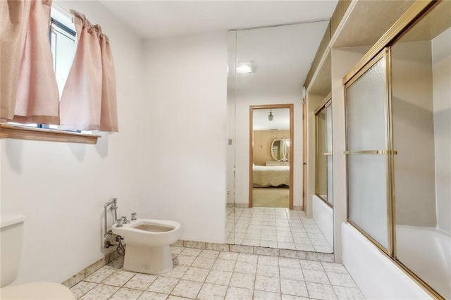 bathroom featuring a bidet, bath / shower combo with glass door, and toilet