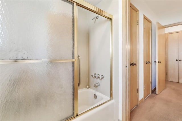 bathroom featuring bath / shower combo with glass door