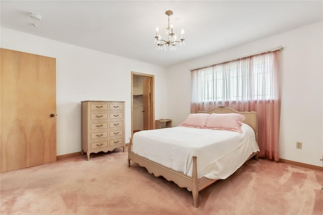 bedroom with carpet floors and a chandelier