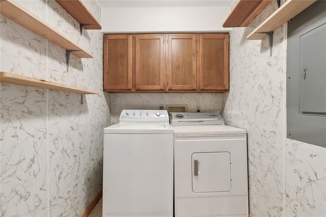 laundry area with cabinets, independent washer and dryer, and electric panel