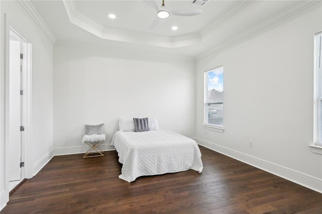 bedroom with dark hardwood / wood-style flooring, a raised ceiling, ceiling fan, and crown molding