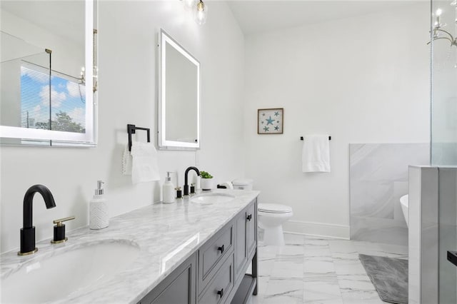 bathroom featuring toilet, vanity, and a notable chandelier