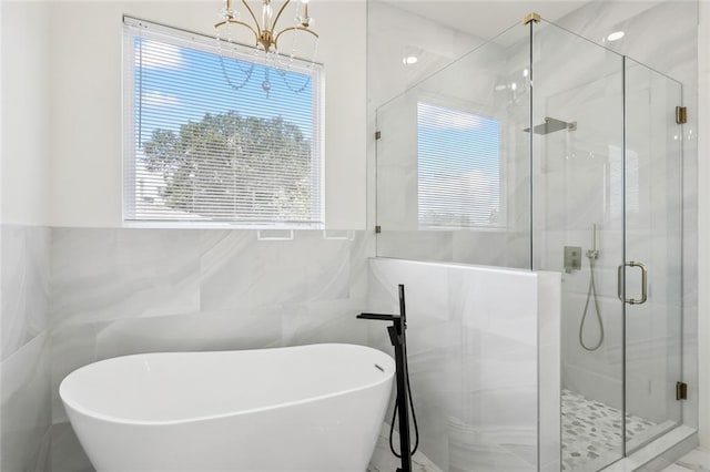 bathroom with tile walls and plus walk in shower