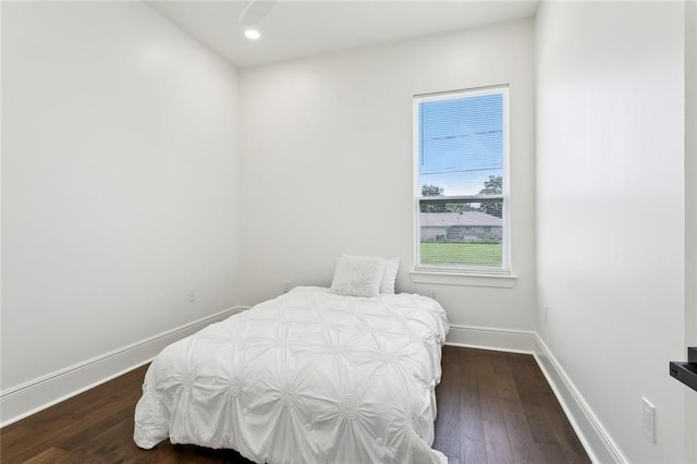 bedroom with dark hardwood / wood-style floors