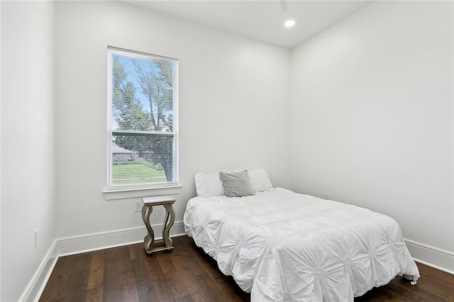 bedroom with dark hardwood / wood-style floors