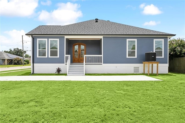 rear view of house with central AC and a yard