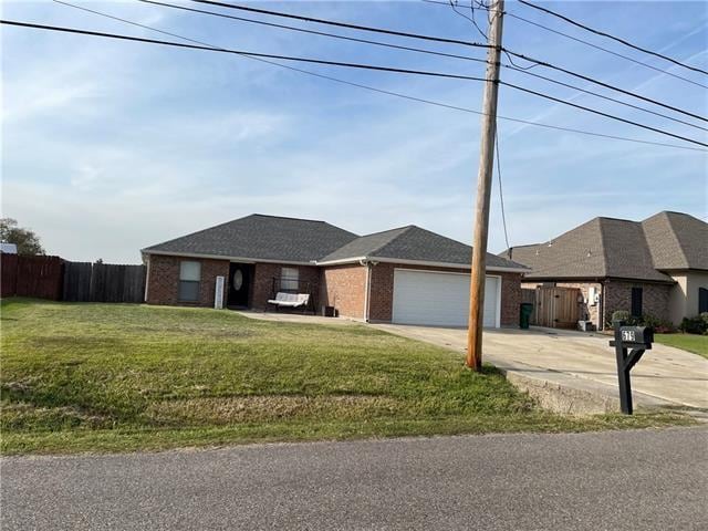 view of front of home with a garage and a front lawn