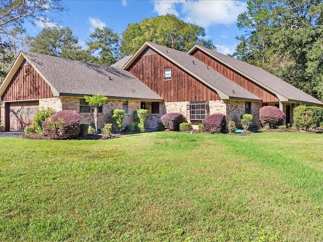 view of front of home with a front yard and a garage