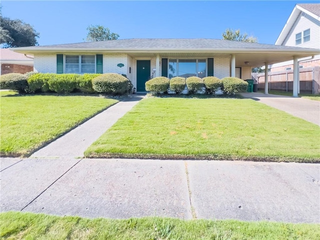 view of front of property featuring a carport and a front lawn