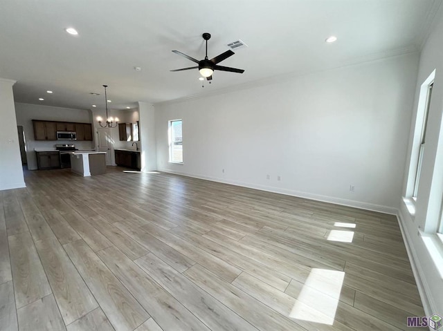 42401 Blue Bay Dr, Ponchatoula, LA 70454 - unfurnished living room with ornamental molding, a chandelier, light wood finished floors, ceiling fan, and baseboards