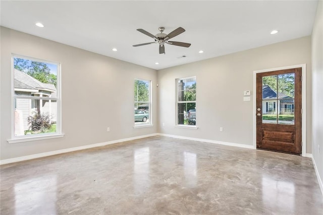 interior space featuring concrete floors, plenty of natural light, and ceiling fan