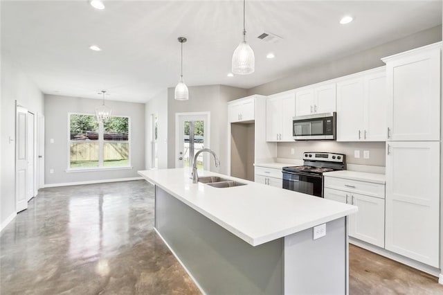 kitchen with sink, concrete floors, hanging light fixtures, and appliances with stainless steel finishes