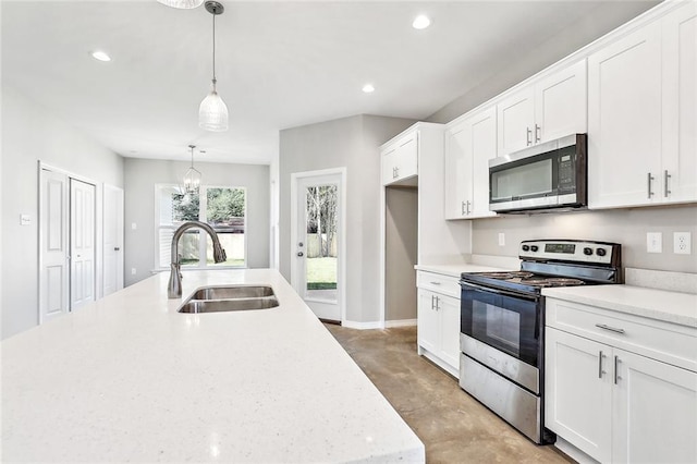 kitchen with white cabinetry, sink, decorative light fixtures, stainless steel appliances, and light stone counters