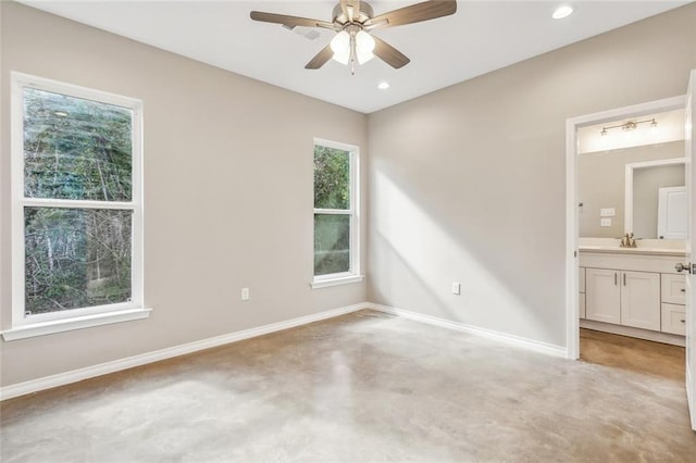 unfurnished bedroom featuring sink, ceiling fan, and ensuite bath