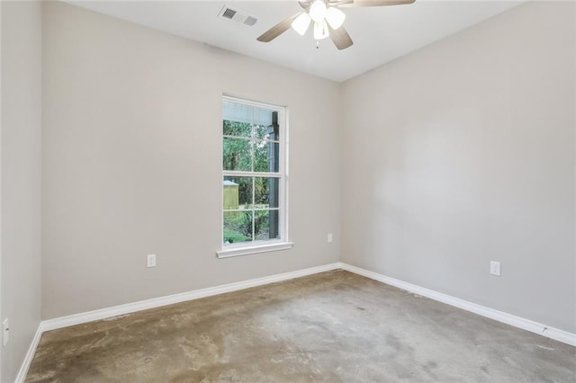 spare room with ceiling fan and concrete floors