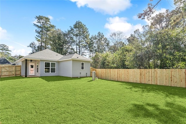 back of house featuring a lawn