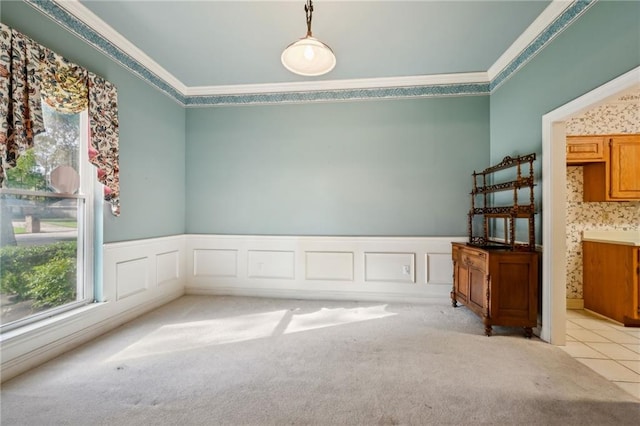 carpeted spare room featuring crown molding