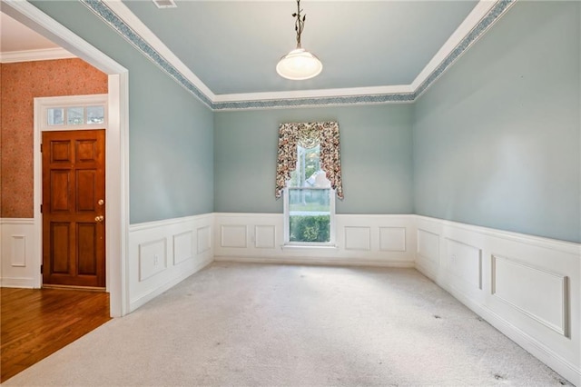 empty room with carpet flooring and crown molding