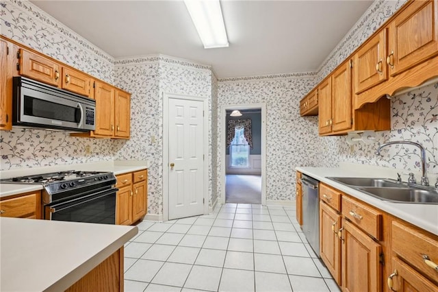 kitchen featuring appliances with stainless steel finishes, sink, and light tile patterned flooring