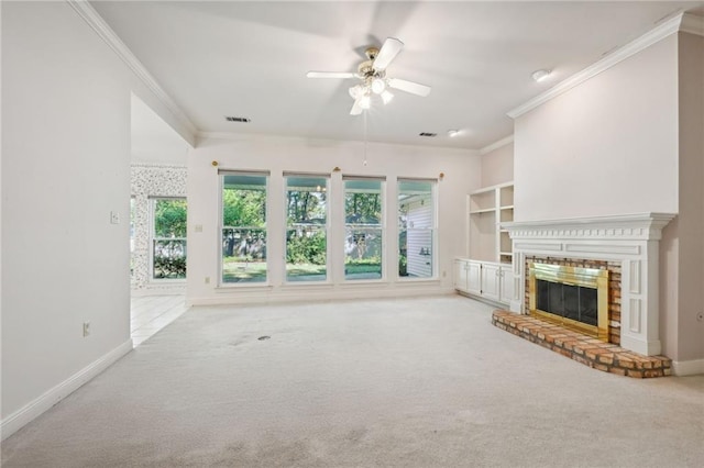 unfurnished living room with ceiling fan, light carpet, ornamental molding, and a fireplace