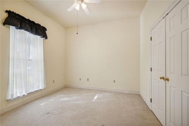 unfurnished bedroom featuring light colored carpet and ceiling fan