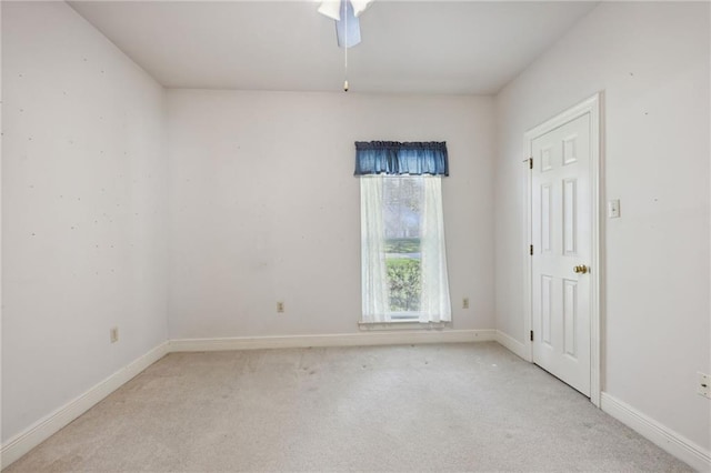 unfurnished room featuring ceiling fan and light carpet