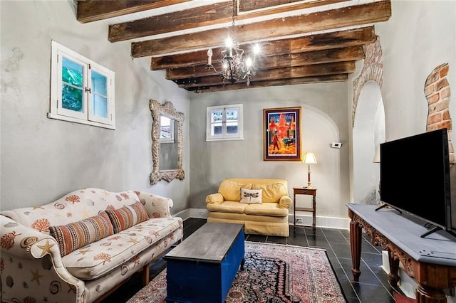 tiled living room featuring beam ceiling and an inviting chandelier