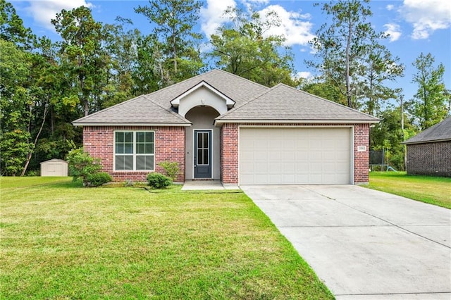 single story home with a front lawn, a storage unit, and a garage