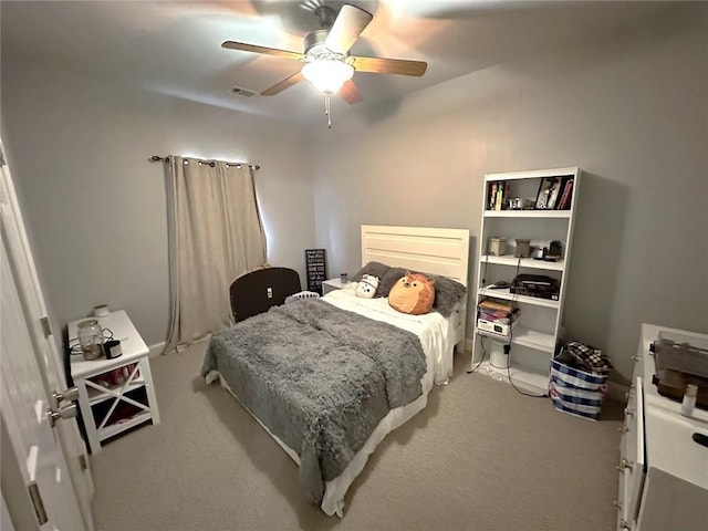 bedroom featuring ceiling fan and light carpet