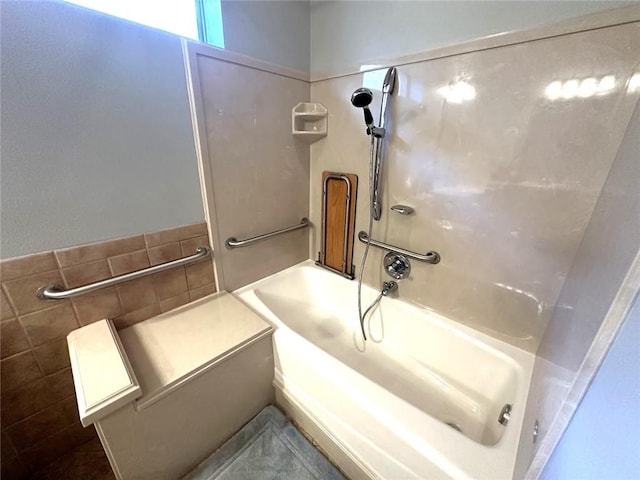 bathroom featuring tile walls and a tub