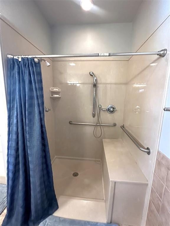 bathroom with tile walls and a shower with shower curtain