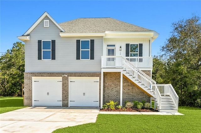 100 Lestin Rd, Slidell, LA 70460 - view of front facade with brick siding, stairway, a garage, a front lawn, and concrete driveway