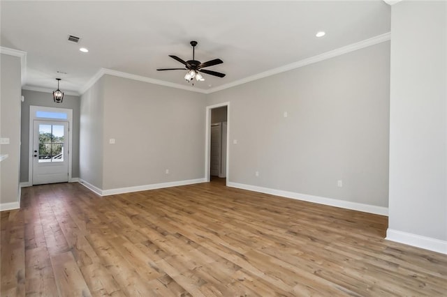 unfurnished room featuring ceiling fan, crown molding, and light hardwood / wood-style flooring