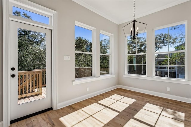 unfurnished sunroom featuring an inviting chandelier