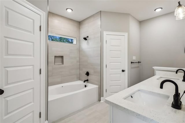 bathroom with vanity and tiled shower / bath combo