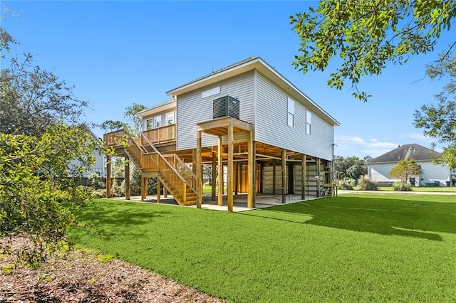 rear view of property with a yard and a wooden deck