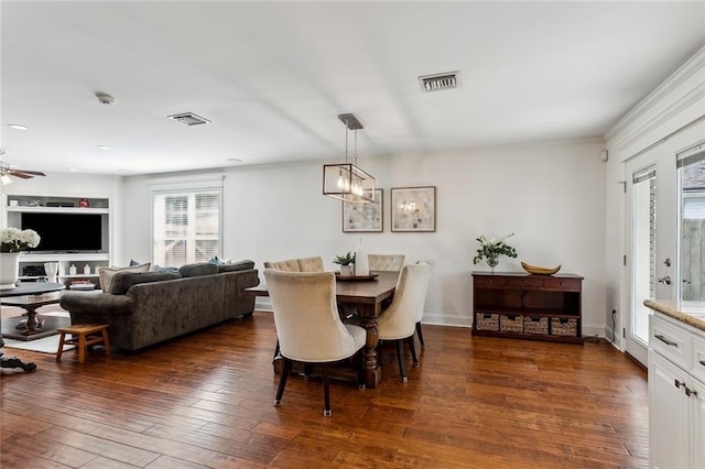 dining area featuring ceiling fan with notable chandelier and dark hardwood / wood-style floors