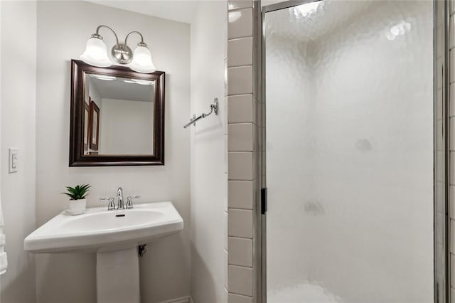 bathroom featuring a shower with door