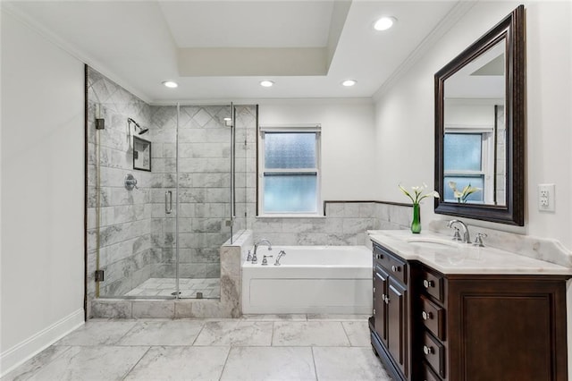 bathroom with ornamental molding, shower with separate bathtub, vanity, and a tray ceiling