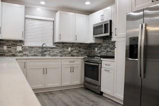 kitchen featuring appliances with stainless steel finishes and white cabinetry