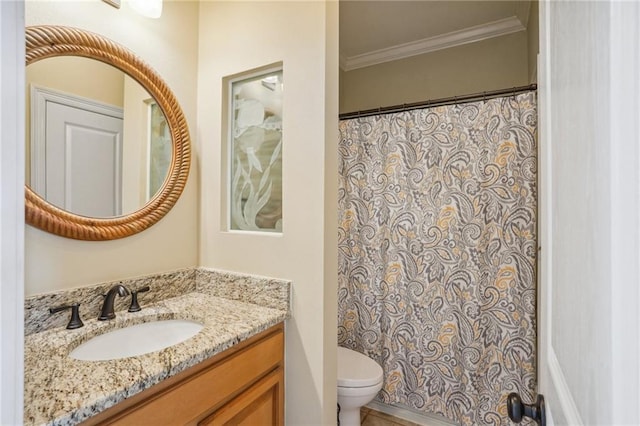 bathroom featuring ornamental molding, vanity, and toilet