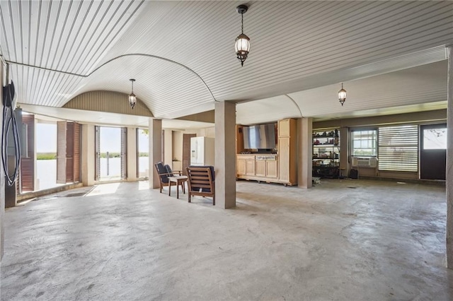 misc room with concrete floors, cooling unit, and vaulted ceiling