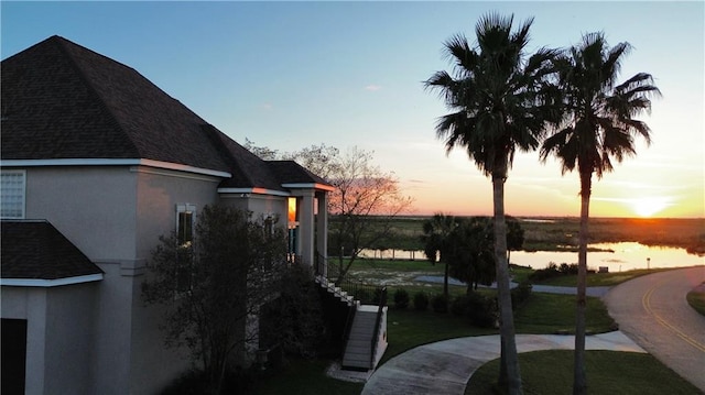 yard at dusk with a water view