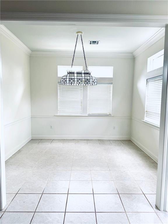 unfurnished dining area with visible vents, crown molding, baseboards, and light tile patterned floors