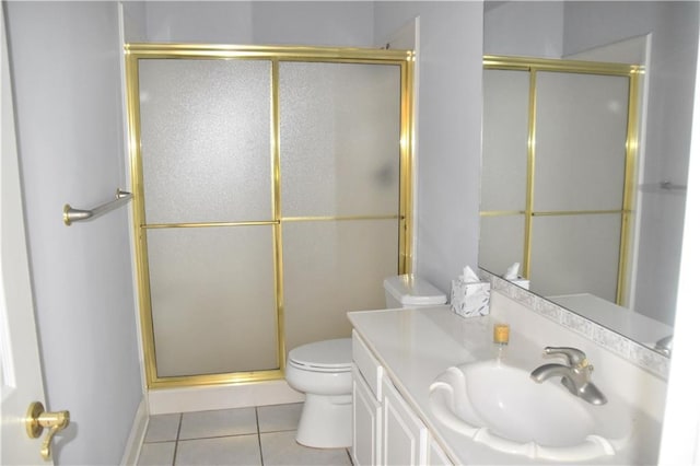 bathroom featuring a stall shower, vanity, toilet, and tile patterned floors