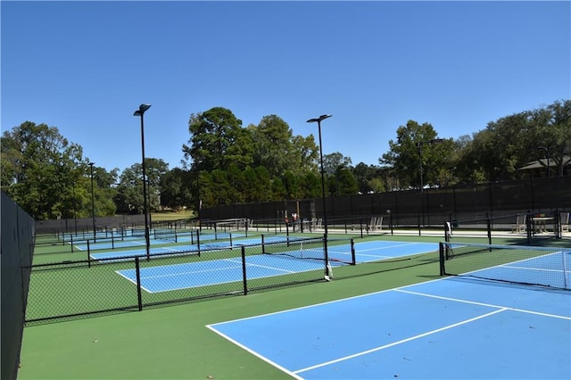 view of tennis court featuring fence