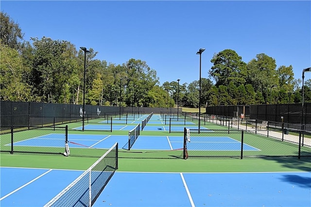 view of sport court featuring fence